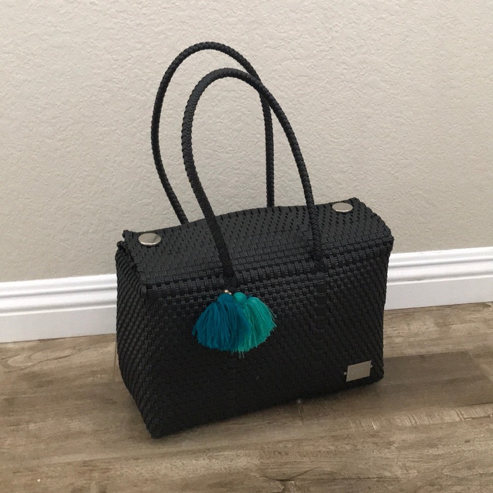 Black handwoven plastic market bag.